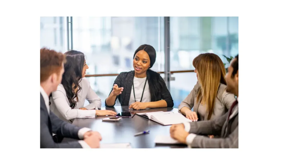 A business support professional leading a meeting with colleagues